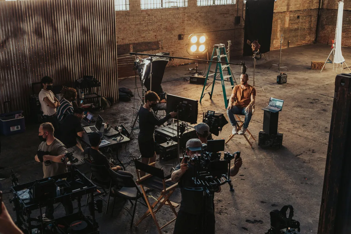 Small production team coordinating call sheet details on a bright film set before call time